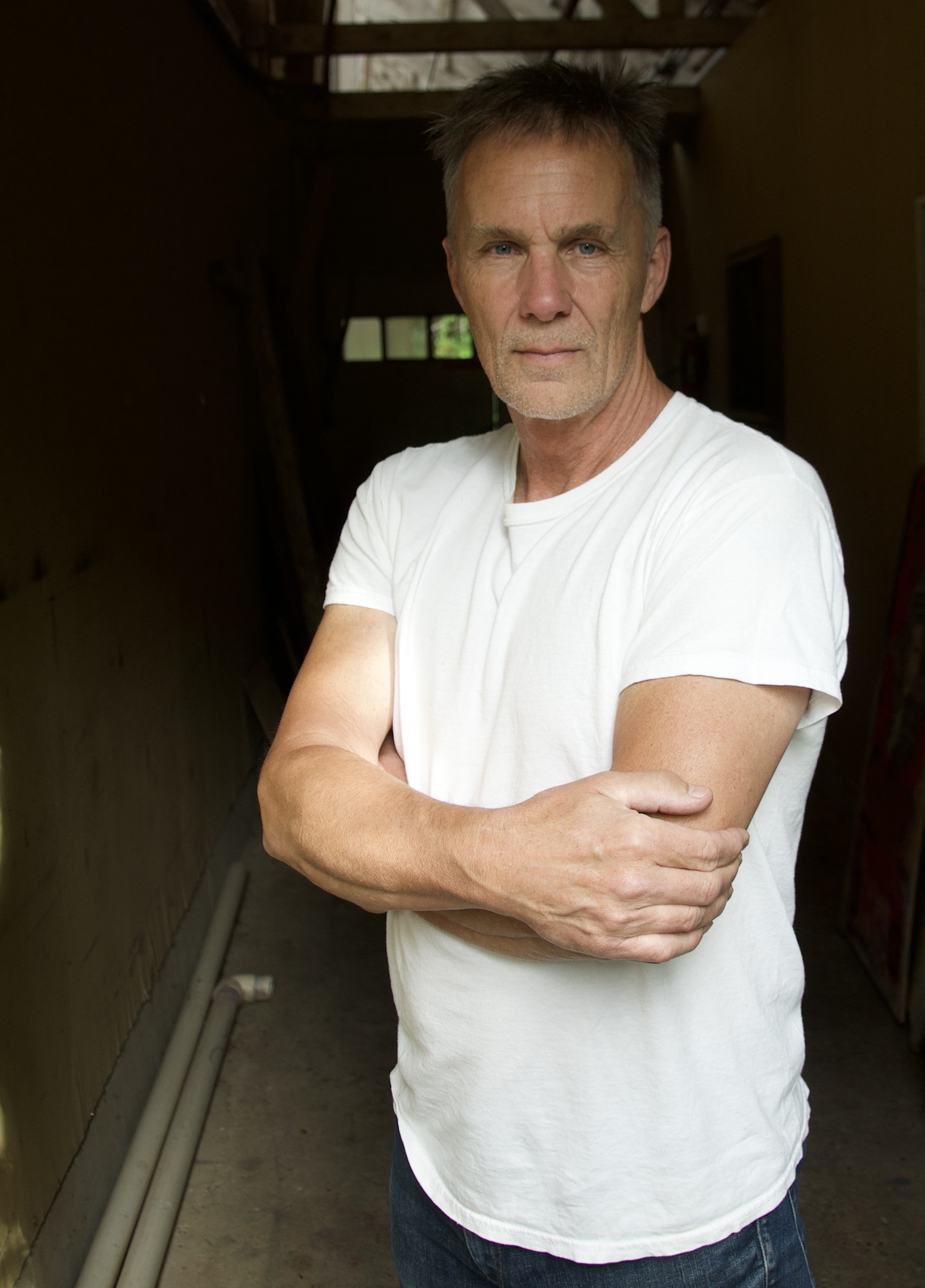 lindsay dakota, founder of naked sports innovations, standing in a doorway in a white t-shirt
