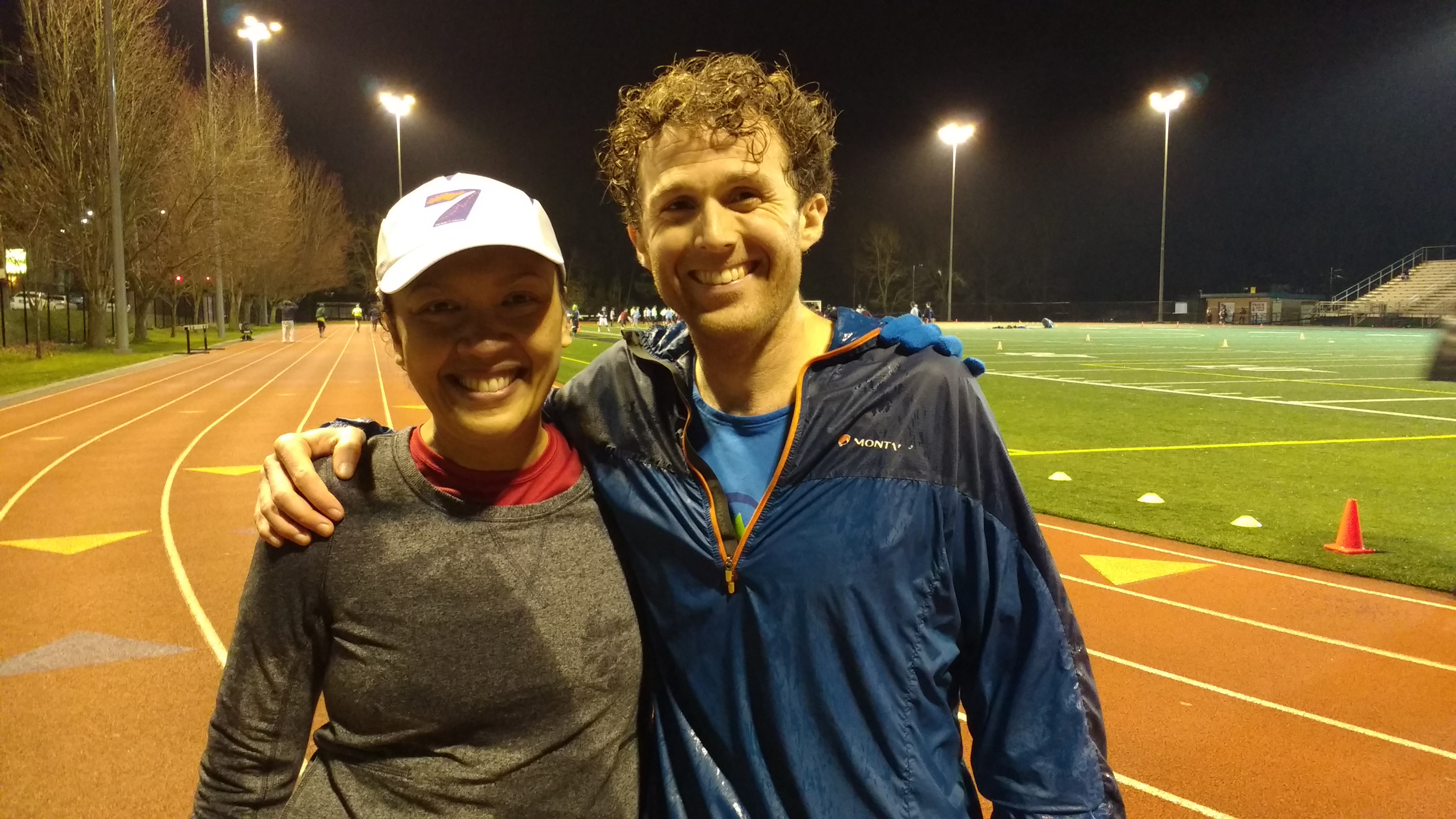 matt urbanski with an athlete on a track at night, 2016
